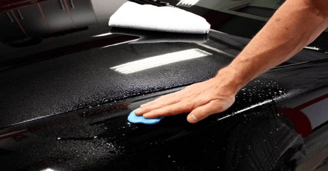 person using rush remover for car