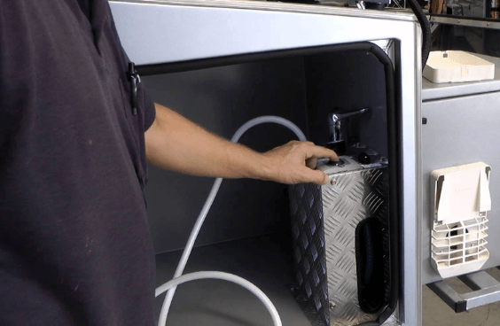 man holding the best tankless water heater for rv